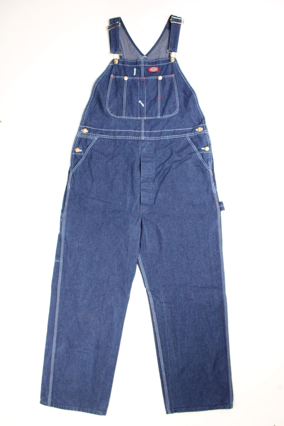 Dickies Dungarees in a blue denim colourway with multiple utility pockets and the logo embroidered on the front. 