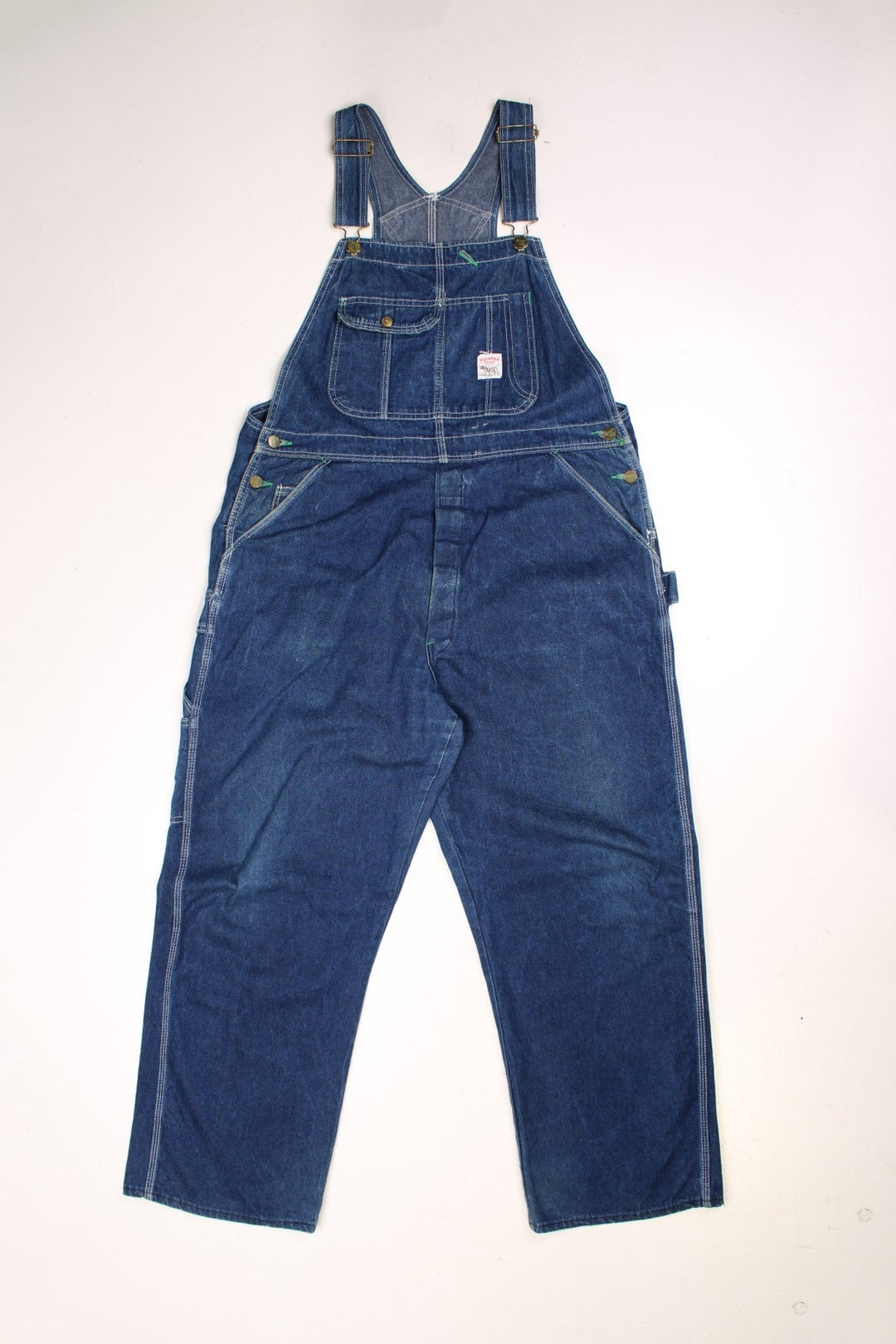 Vintage Pointer dungarees with contrast stitching, multiple pockets, a hammer loop, and logos on the front and back.