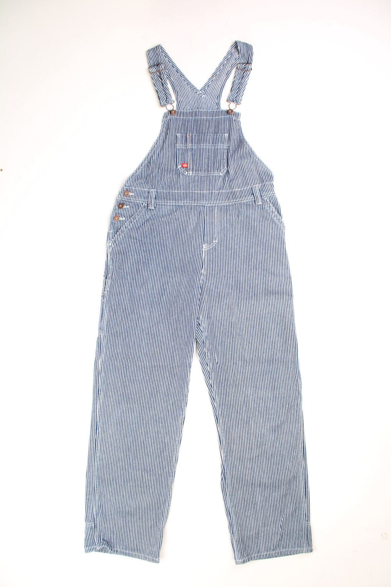 Dickies Dungarees in a blue and white striped colourway with multiple utility pockets and the logo embroidered on the front. 