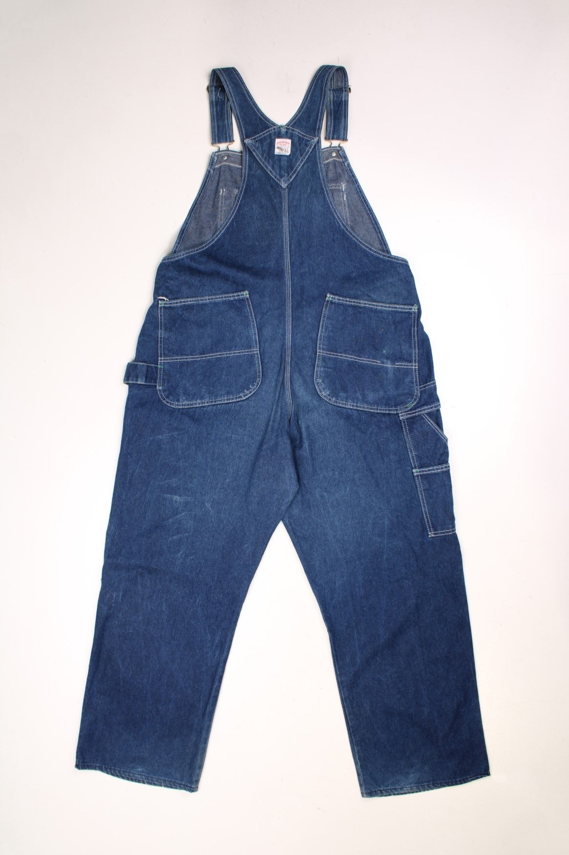 Vintage Pointer dungarees with contrast stitching, multiple pockets, a hammer loop, and logos on the front and back.