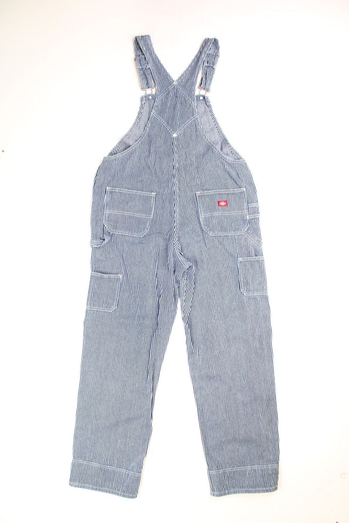 Dickies Dungarees in a blue and white striped colourway with multiple utility pockets and the logo embroidered on the front. 