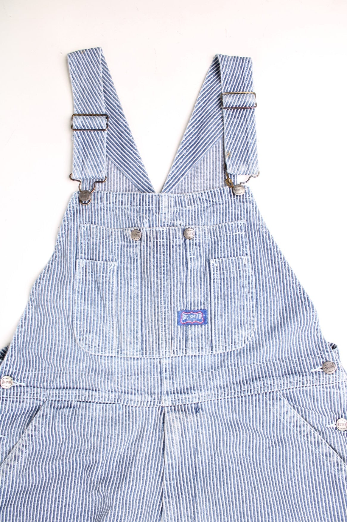 Big Smith Dungarees in a blue and white striped colourway with multiple utility pockets and the logo embroidered on the front. 