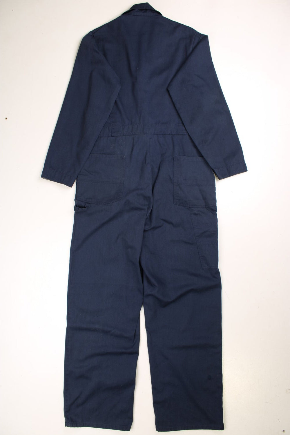 Ben Davis long-sleeved boiler suit/overalls in navy blue with multiple pockets, zip and button closure.