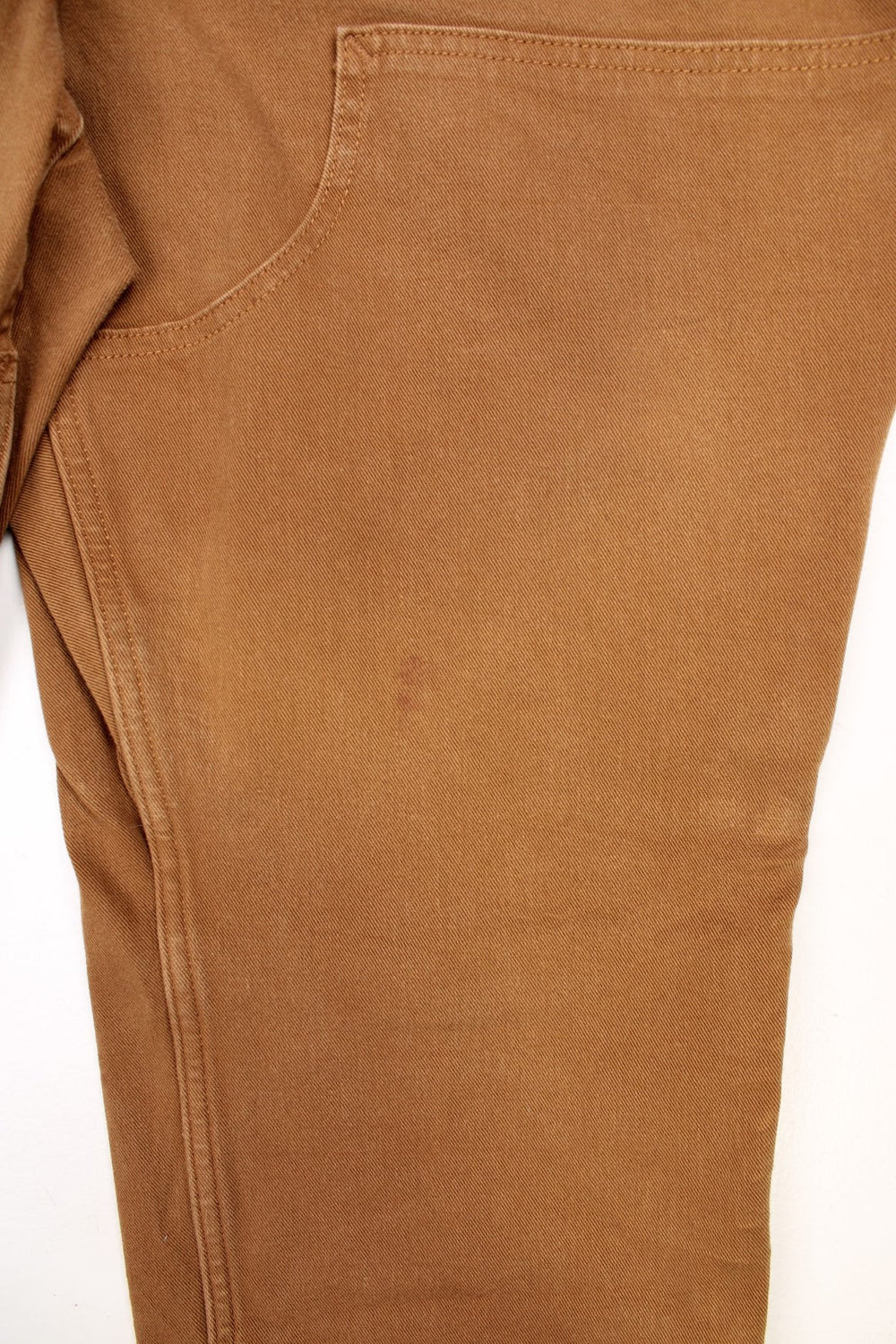 Ochre brown Carhartt carpenter-style dungarees with multiple pockets. 