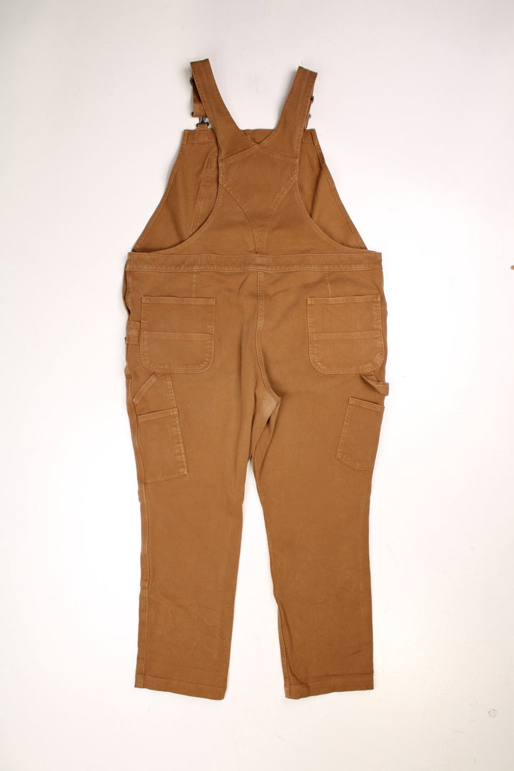 Ochre brown Carhartt carpenter-style dungarees with multiple pockets. 