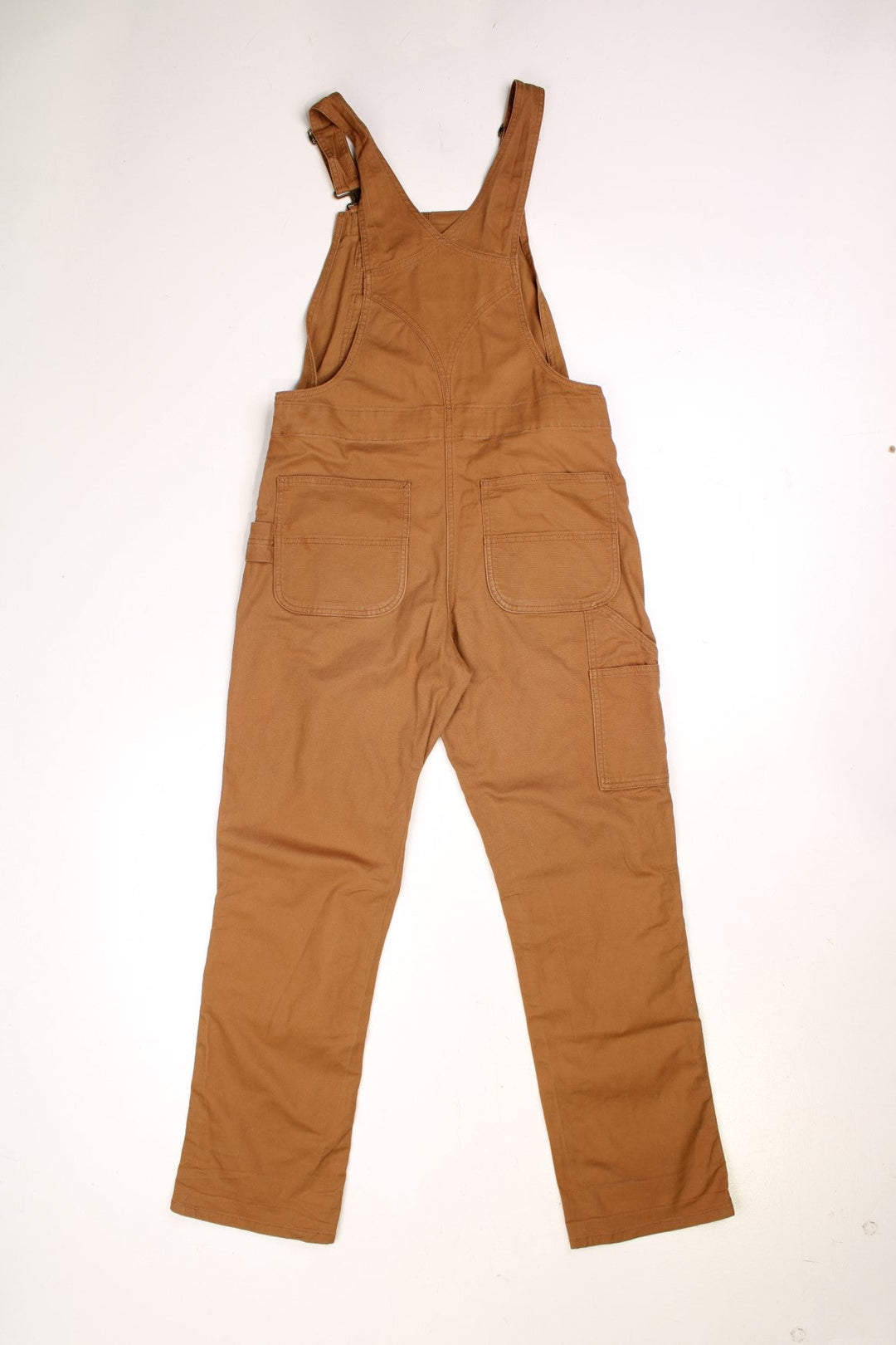 Ochre brown Carhartt carpenter-style dungarees with multiple pockets and sewn-in elastic to expand the waist size. 