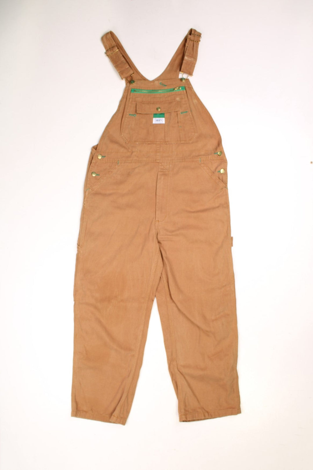 Tan Liberty dungarees with green accents, multiple pockets, logos front and back. 