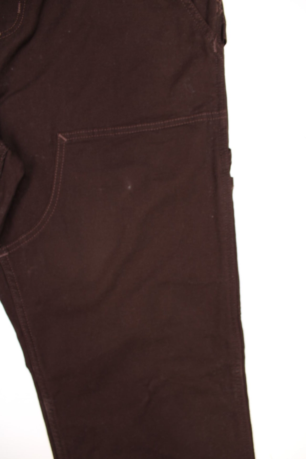 Dark brown carpenter-style Carhartt dungarees with multiple pockets, branded hardware, and a hammer loop.  