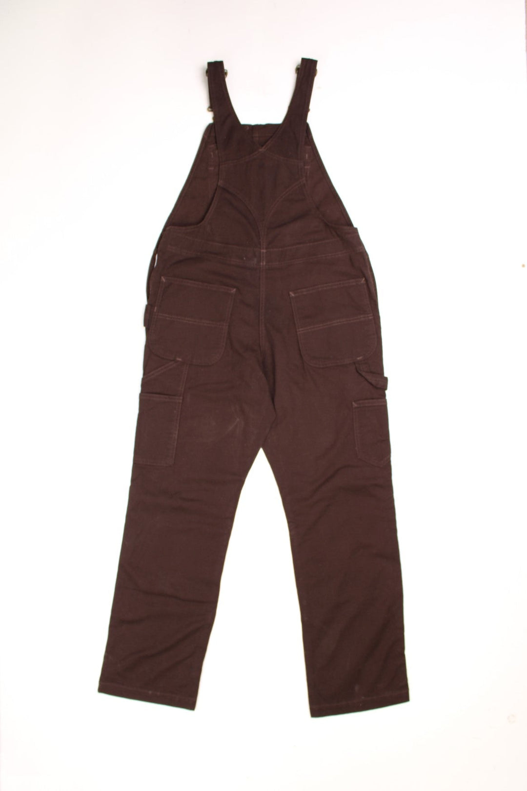 Dark brown carpenter-style Carhartt dungarees with multiple pockets, branded hardware, and a hammer loop.  