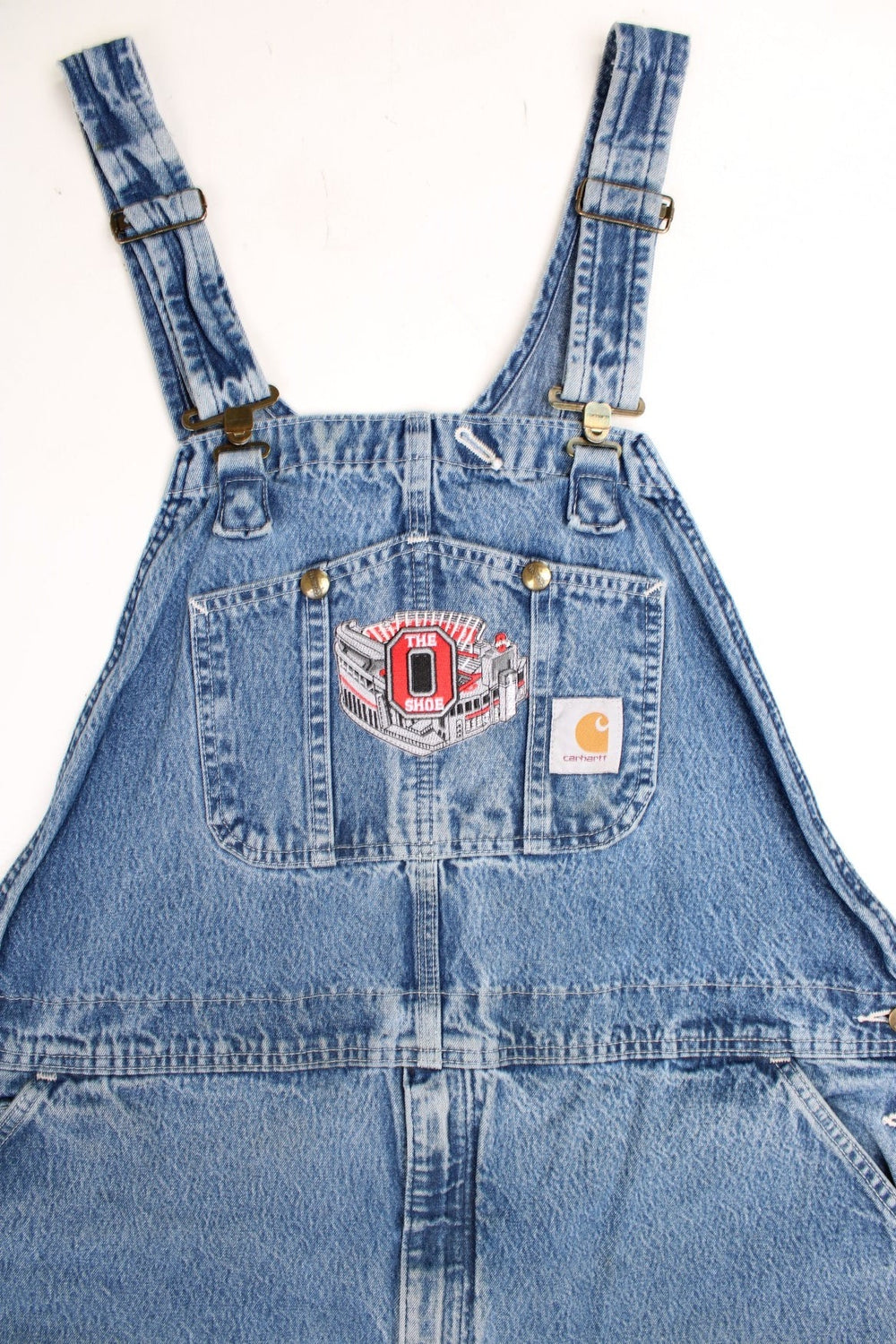 Vintage Carhartt denim bib overalls/dungarees with an Ohio Stadium embroidered badge. Features logo on the pocket.