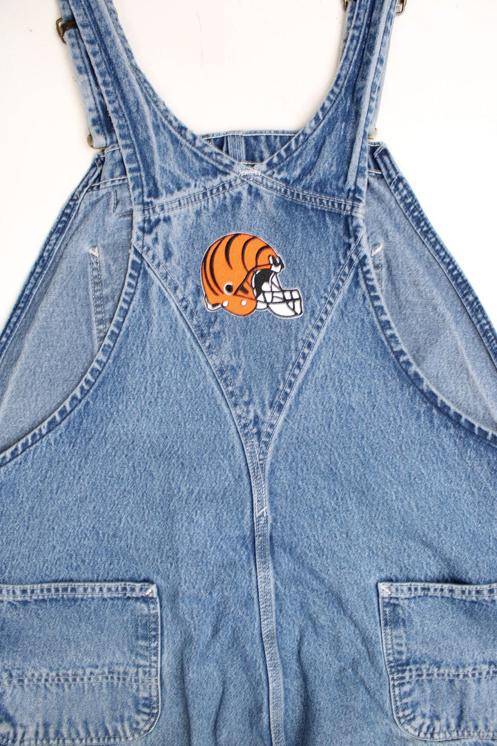 Vintage Carhartt denim bib overalls/dungarees with an Ohio Stadium embroidered badge. Features logo on the pocket.