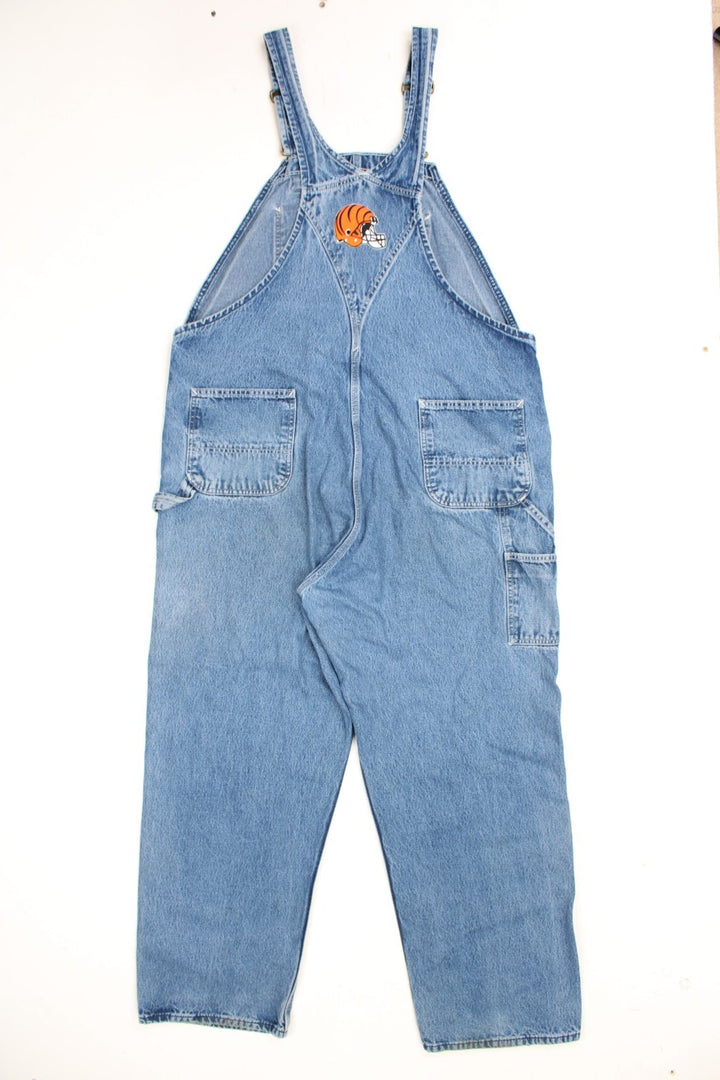 Vintage Carhartt denim bib overalls/dungarees with an Ohio Stadium embroidered badge. Features logo on the pocket.