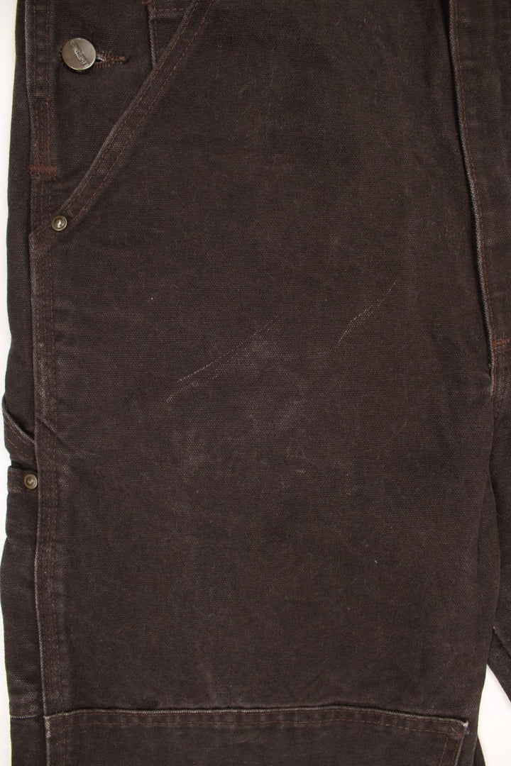 Vintage Carhartt double knee brown overalls/dungarees. Features multiple pockets and embroidered leather logo. 