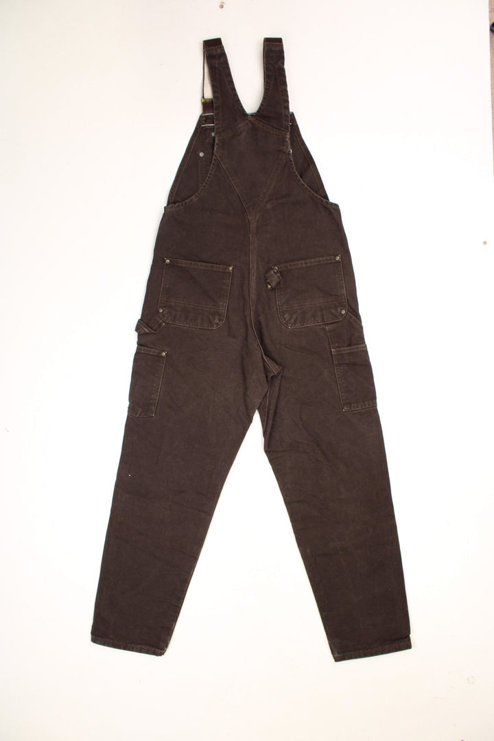 Vintage Carhartt double knee brown overalls/dungarees. Features multiple pockets and embroidered leather logo. 