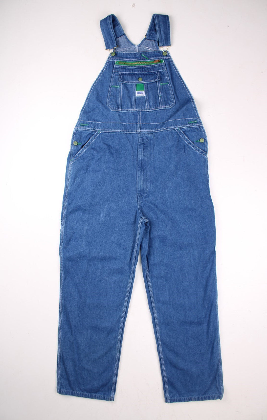 Vintage Liberty denim dungarees in blue with multiple pockets, branded hardware, and a Liberty Overalls patch on the front.