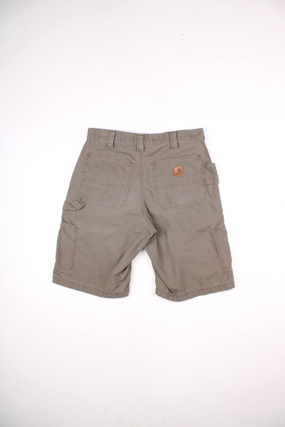 Carhartt shorts in khaki with multiple pockets, zip and button closure, and a leather logo patch on the back.