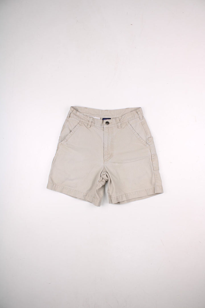 Patagonia shorts in tan with multiple pockets, zip and button closure, and a small logo on the back.