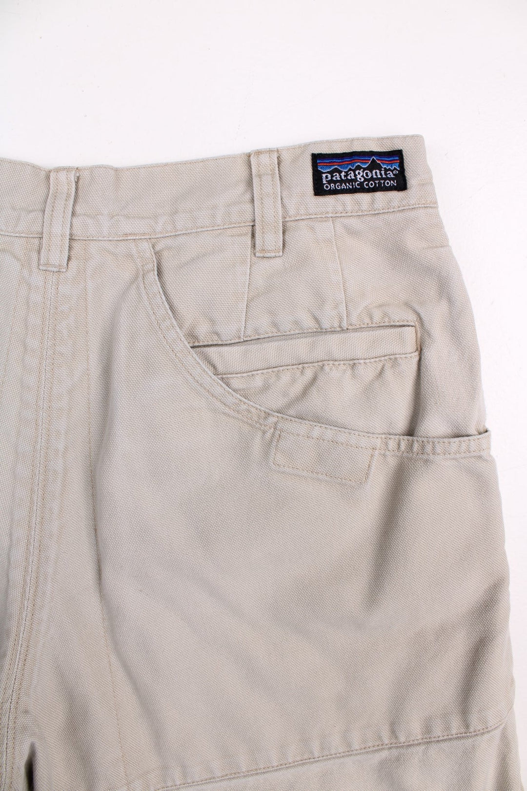 Patagonia shorts in tan with multiple pockets, zip and button closure, and a small logo on the back.