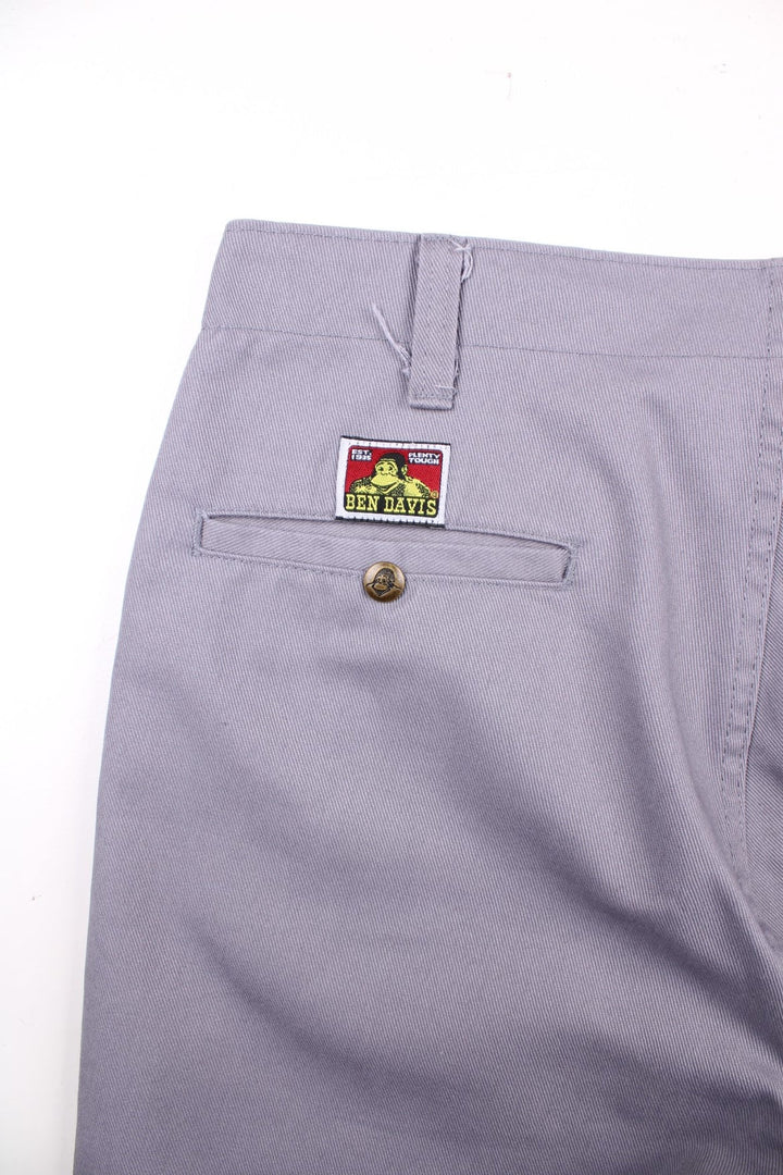 Ben Davis work  trousers in grey with multiple pockets, zip and button closure, and a logo patch on the back.