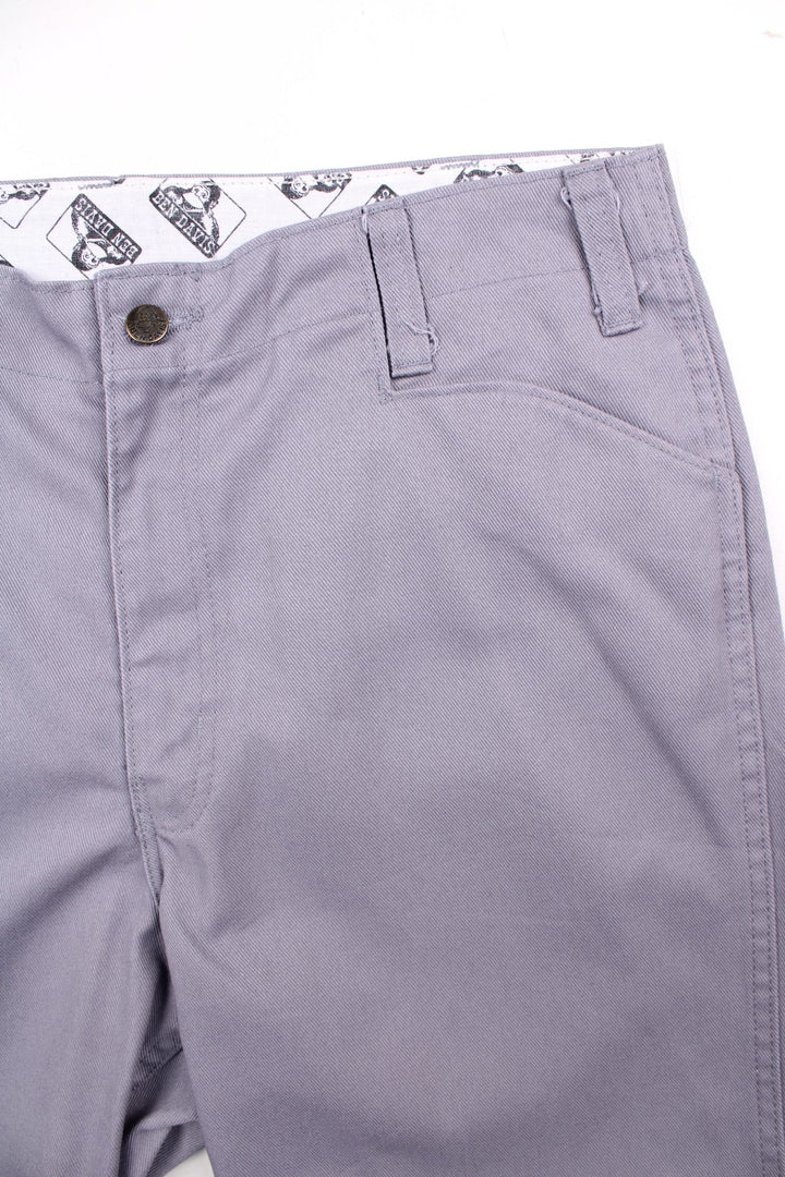 Ben Davis work  trousers in grey with multiple pockets, zip and button closure, and a logo patch on the back.