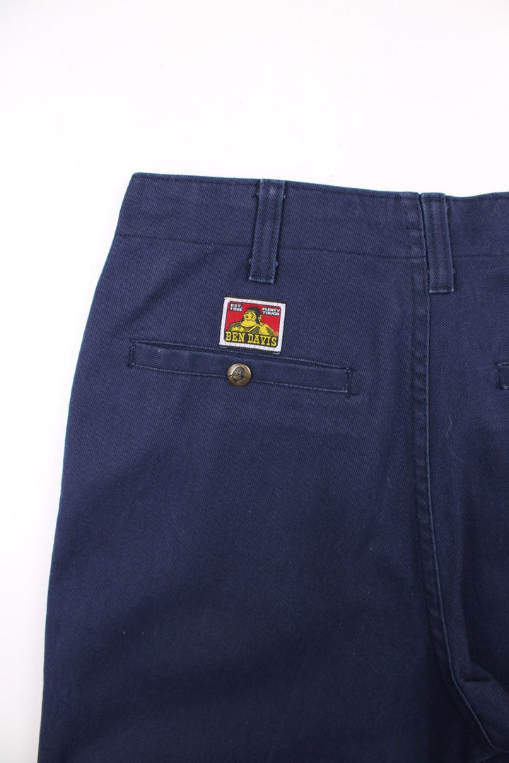 Ben Davis work trousers in navy blue with multiple pockets, zip and button closure, and a logo patch on the back pocket.