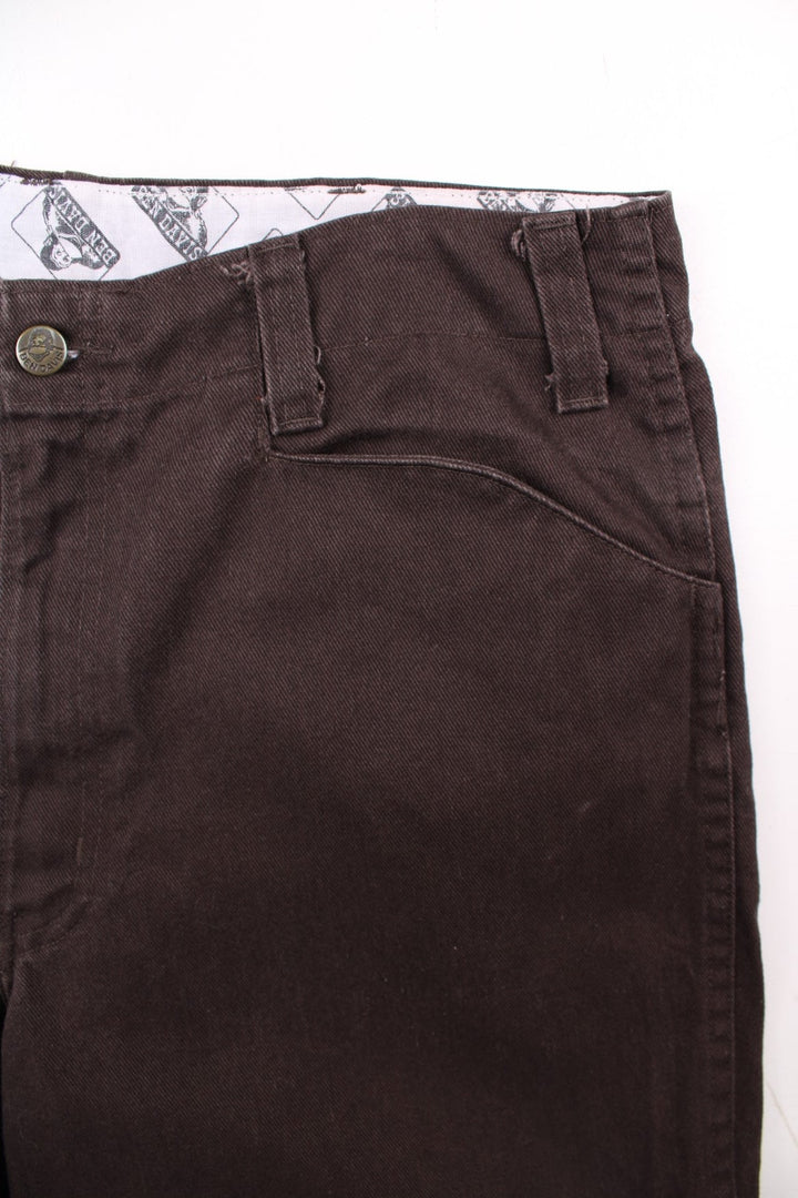 Ben Davis corduroy trousers in dark brown with multiple pockets, zip and button closure, and a logo patch on the back pocket.