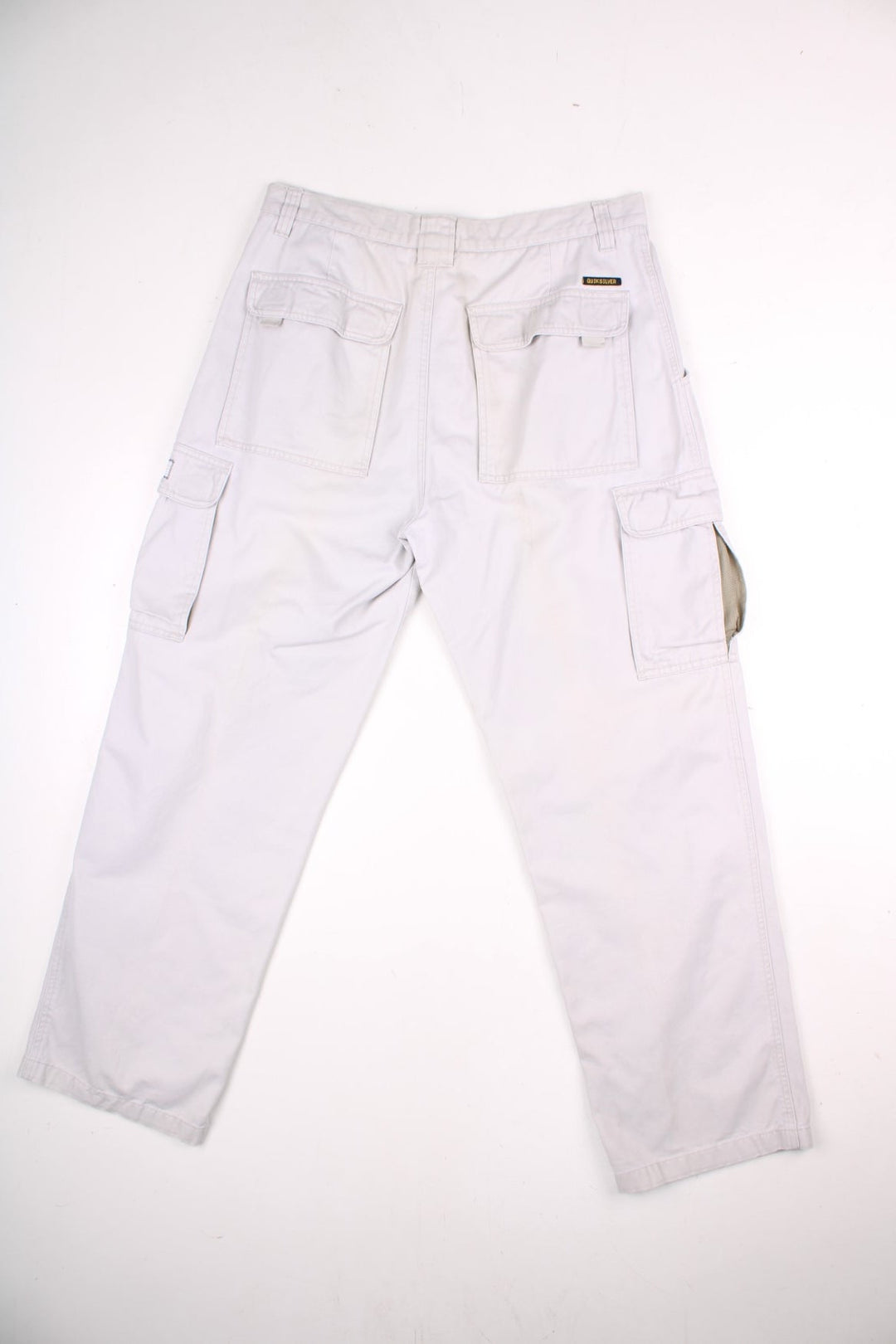 Quiksilver corduroy trousers in tan with multiple pockets, zip and button closure, and a logo patches on the back and side pockets.