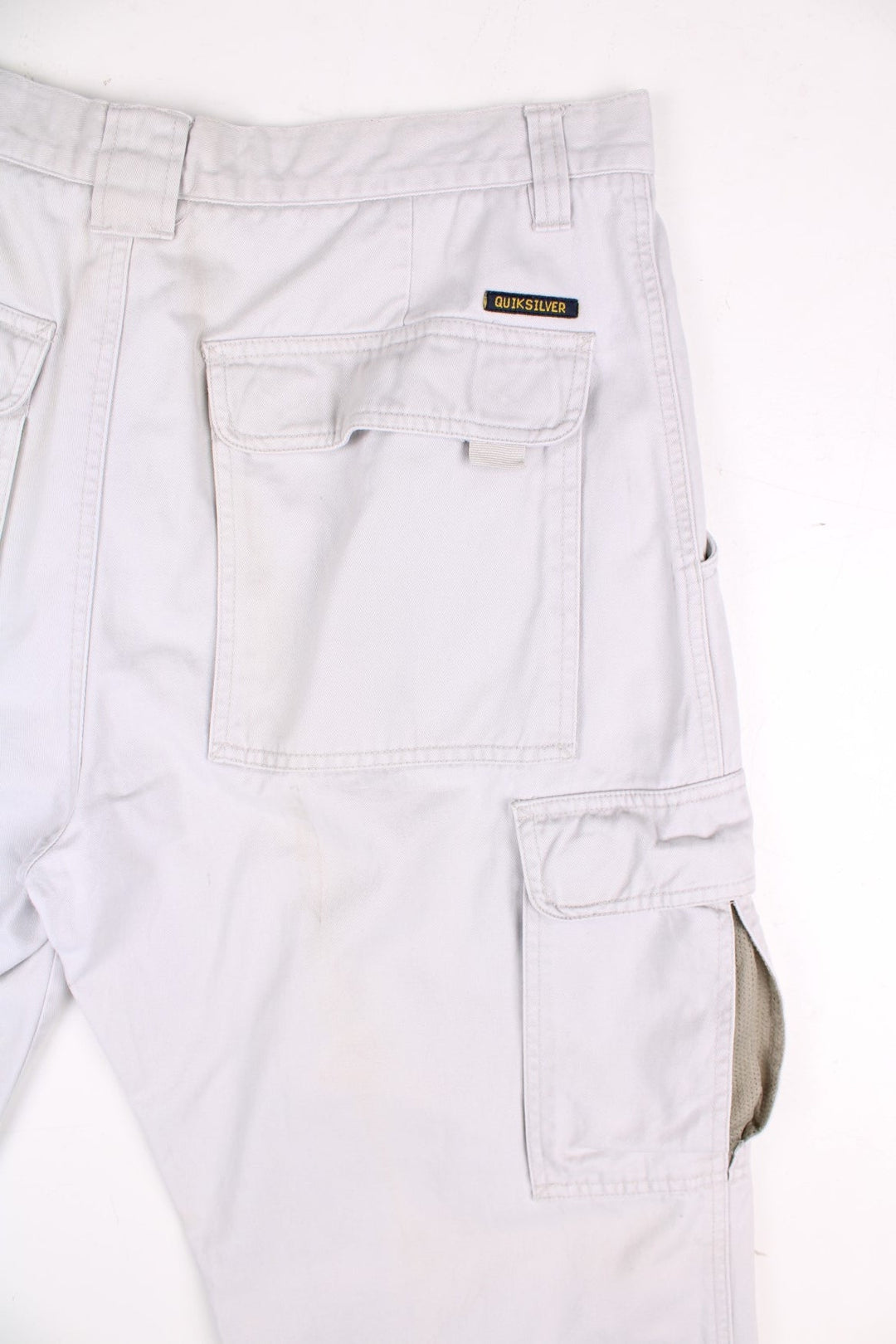 Quiksilver corduroy trousers in tan with multiple pockets, zip and button closure, and a logo patches on the back and side pockets.