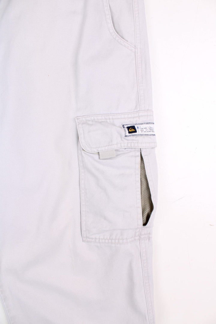 Quiksilver corduroy trousers in tan with multiple pockets, zip and button closure, and a logo patches on the back and side pockets.