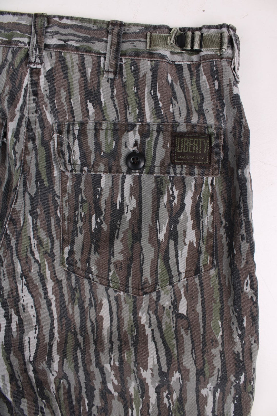 Vintage Realtree camouflage trousers in green and brown with multiple pockets and zip and button closure.