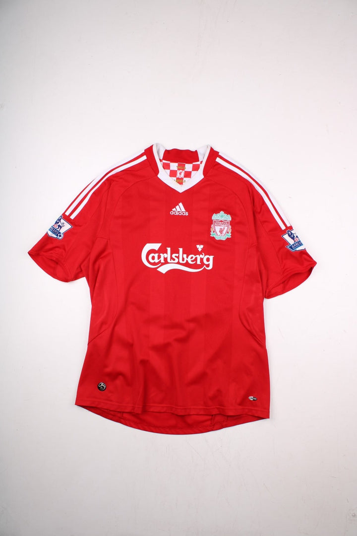 Liverpool 2008/09 Umbro Football Shirt in the red away kit colourway, features embroidered logos and badge on the front, and Gerrard number 8 printed on the back.