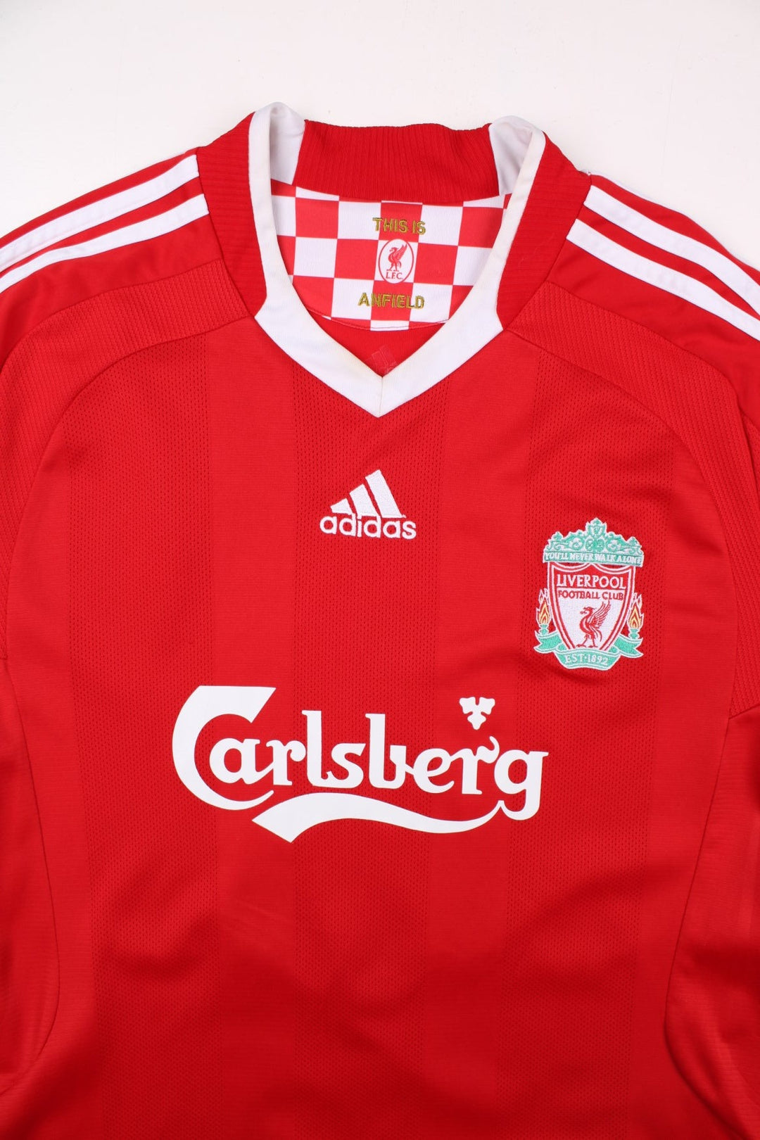 Liverpool 2008/09 Umbro Football Shirt in the red away kit colourway, features embroidered logos and badge on the front, and Gerrard number 8 printed on the back.