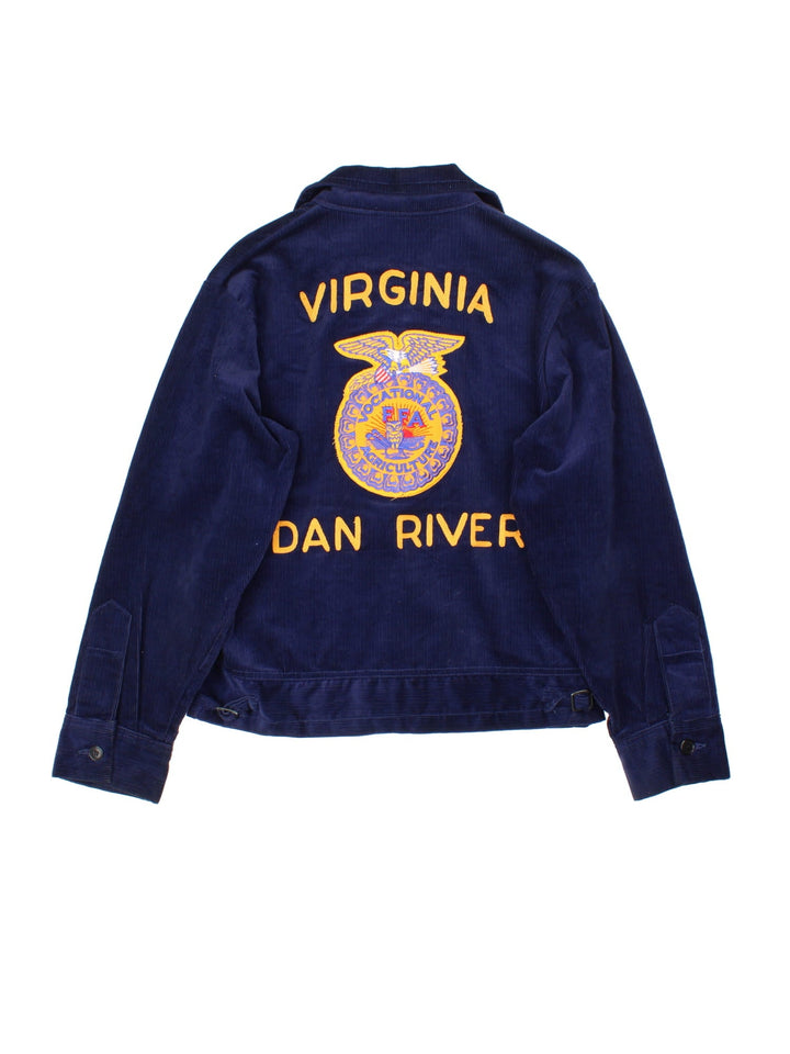 Vintage FFA Agricultural Education Jacket in a blue colourway. Zips up and has side pockets, v neck collar, and has the logo and spell out embroidered on the front and back.