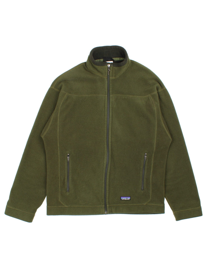 Patagonia Fleece Jacket in a green colourway. Full zip and double pocket on the front. Embroidered classic logo badge on the front at the bottom.