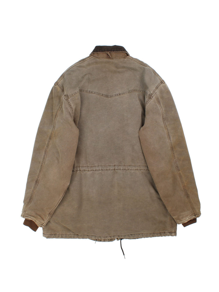 Carhartt Barn Chore Jacket in a brown colourway. Zip and button up with side pockets, corduroy collar, and has the logo embroidered on the front.