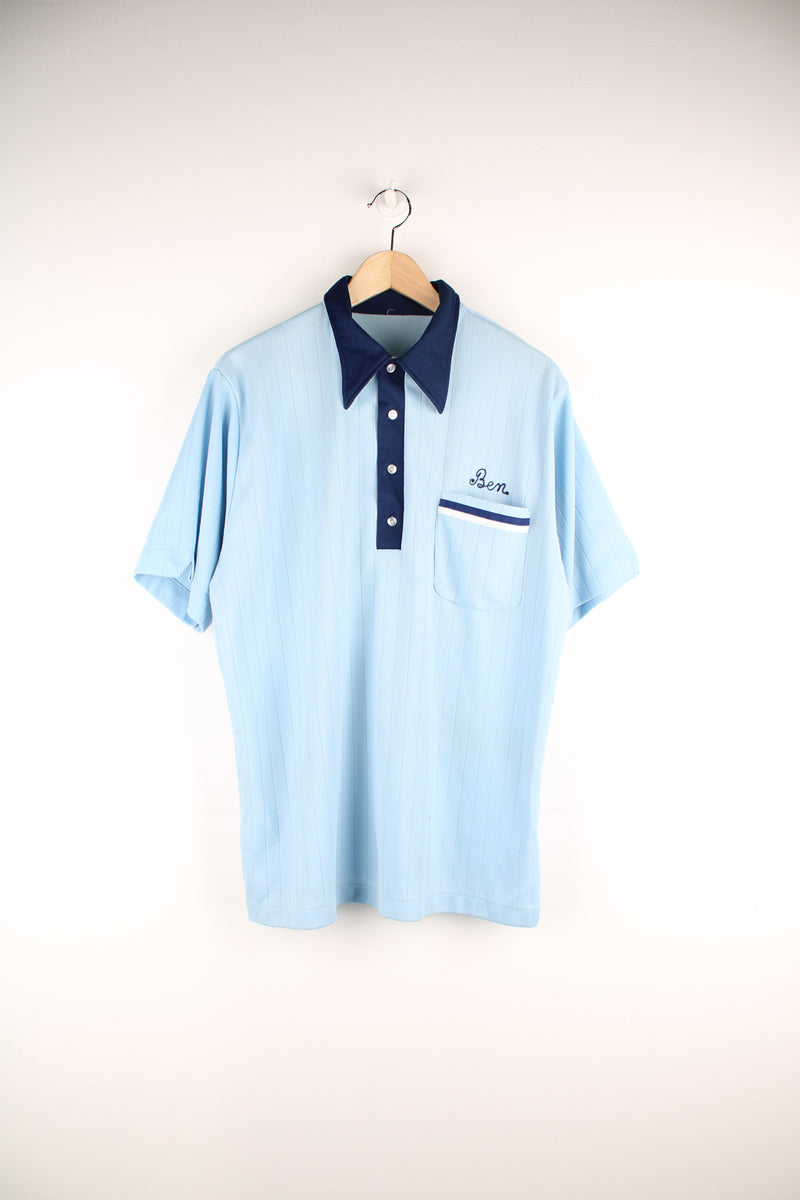 Vintage looks likes 60's/70's blue tone nylon polo style bowling shirt with dagger collar and chain stitch spell-outs on the front and back