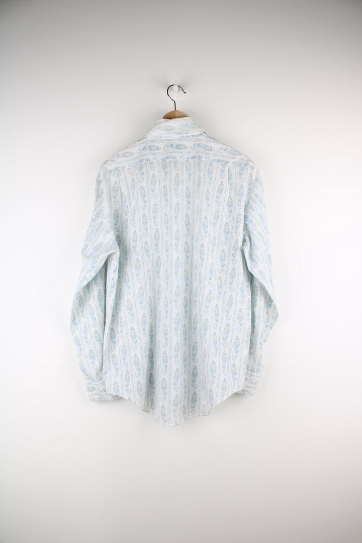 Vintage 1950's John Wells western shirt in off white. Features blue floral / paisley print and dagger collar 