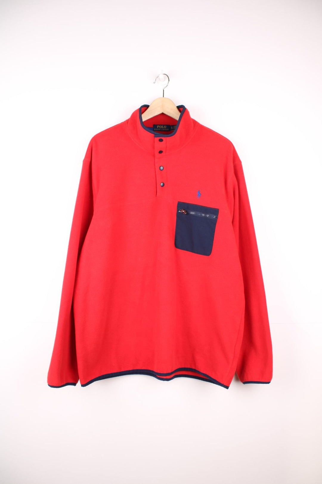 Red Polo quarter-zip with snap closure and contrasting navy blue trim and zip pocket. Classic Polo logo embroidered in blue. 