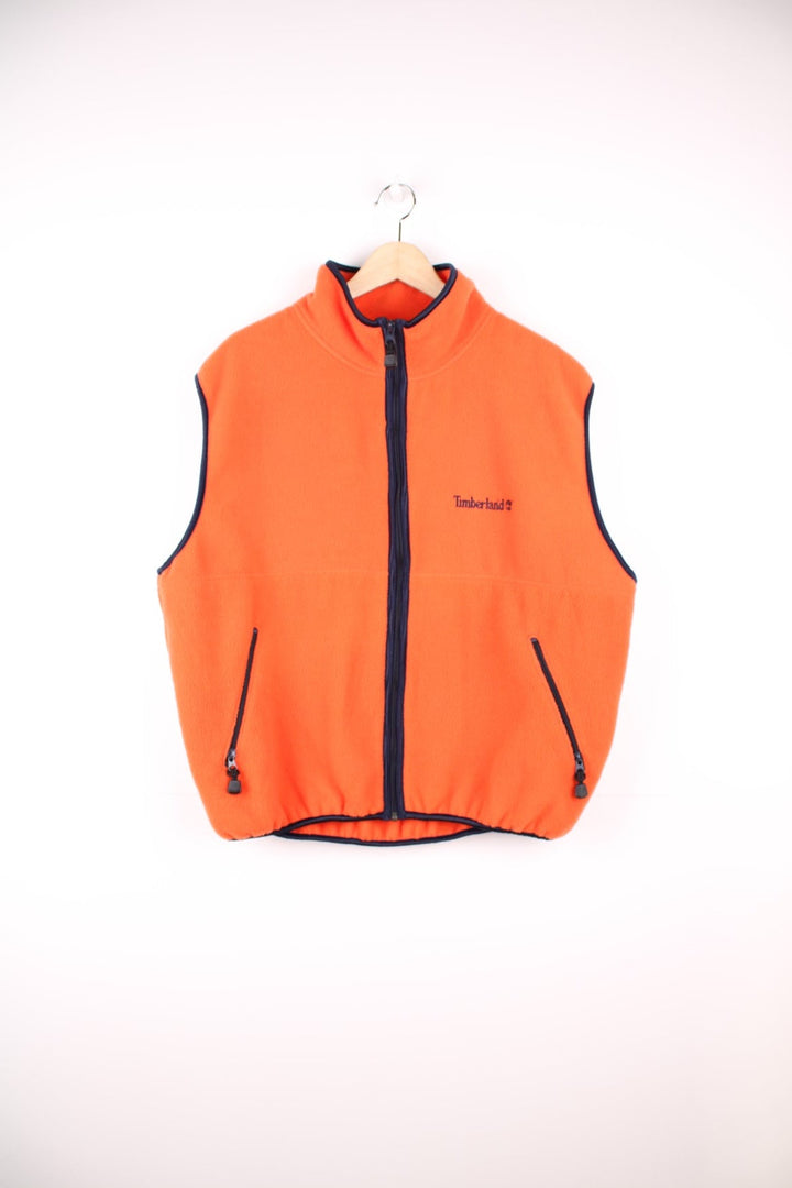 Orange Timberland zip-through fleece gilet with two side zip pockets and embroidered logo. 