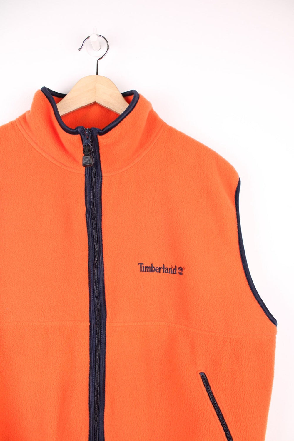 Orange Timberland zip-through fleece gilet with two side zip pockets and embroidered logo. 