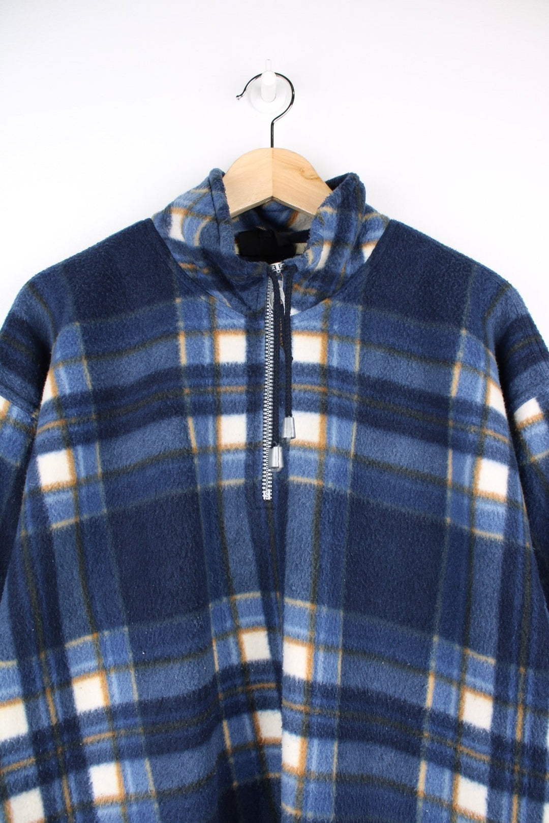 Paul & Shark 1/4 zip fleece in blue, white, and brown check with two pockets and drawstring adjusters at the collar and hem.