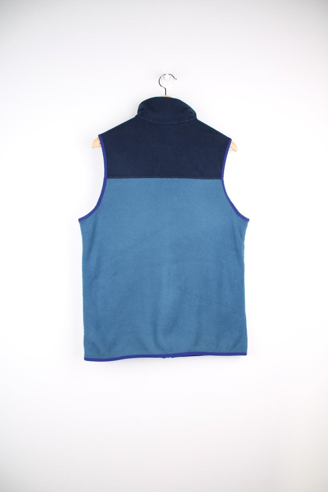 Patagonia fleece gilet in blue with darker blue top half and piping, zip closure and pockets with red zip toggles, and a small logo on the chest.