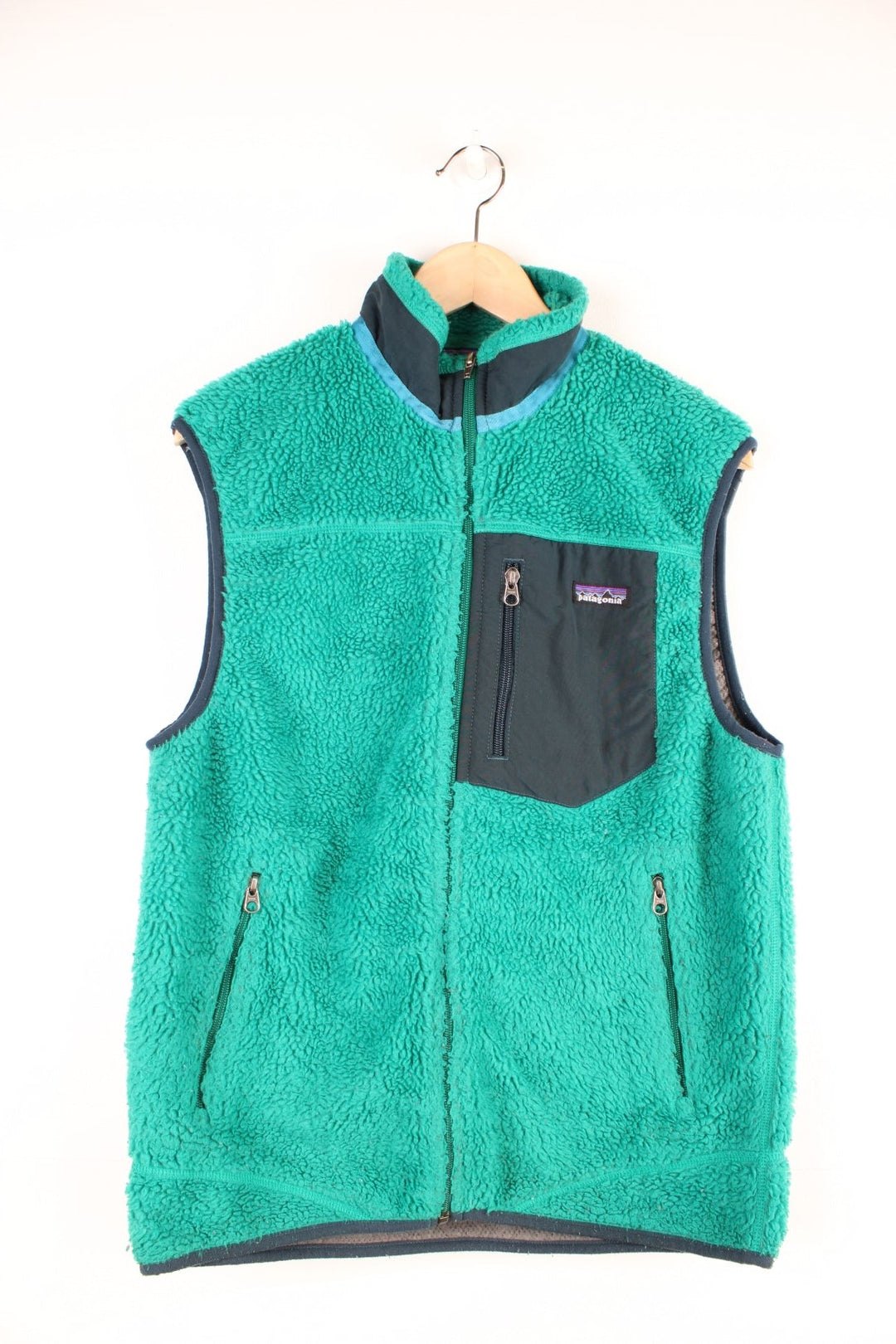 Green Patagonia zip-up fleece gilet with blue accents, three zipped pockets and a logo patch.  