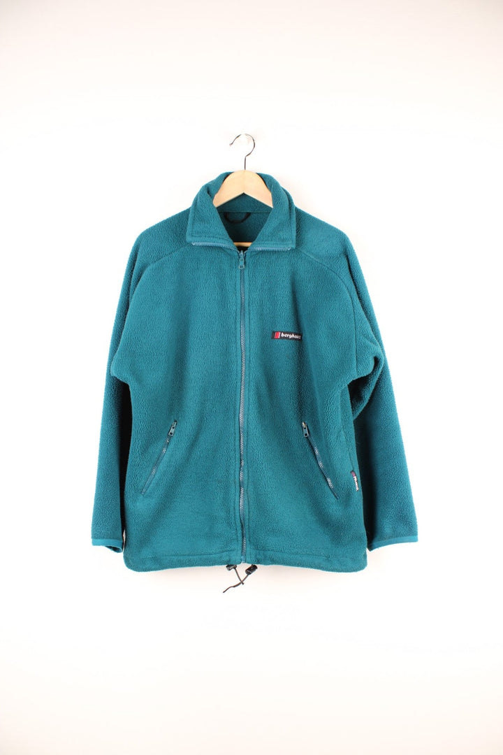 Deep turquoise Berghaus zip-up fleece with waist adjusters, two zipped pockets and an embroidered logo.  