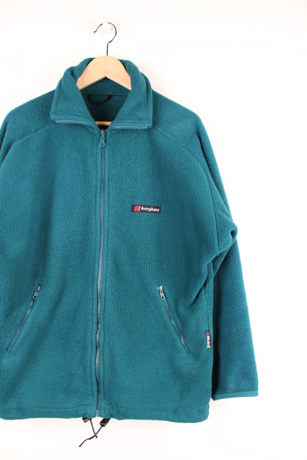 Deep turquoise Berghaus zip-up fleece with waist adjusters, two zipped pockets and an embroidered logo.  