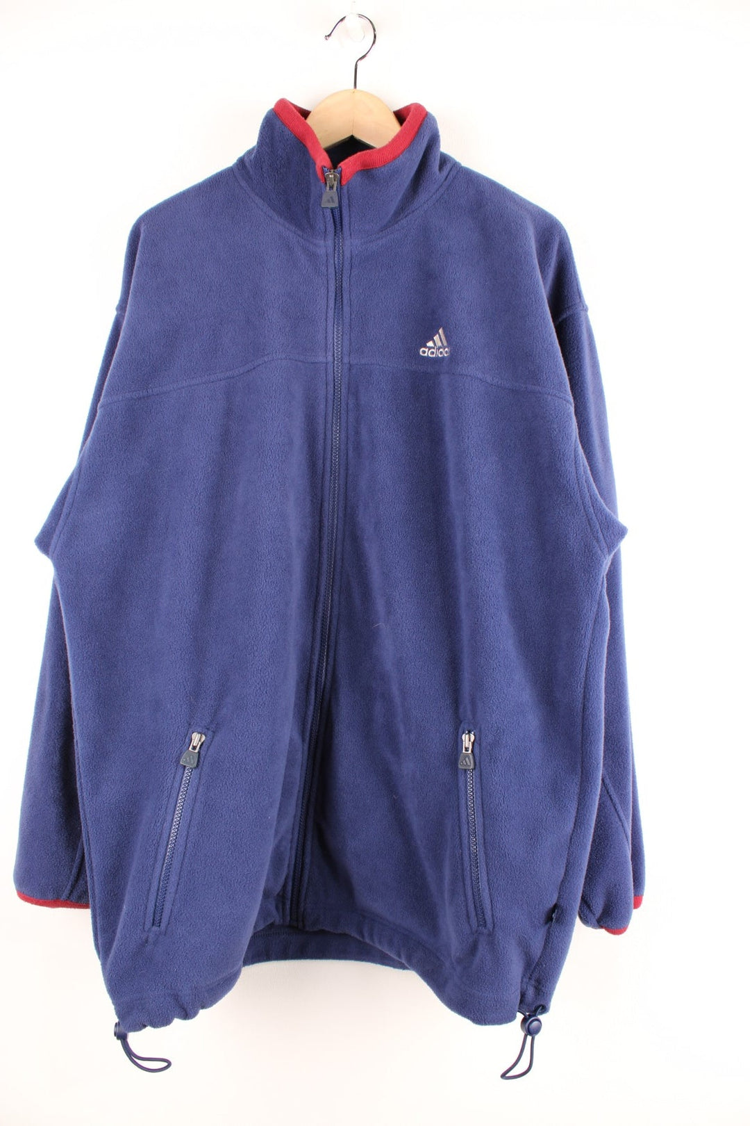 Dark blue Adidas zip-up fleece with red accents, two zipped pockets and an embroidered logo. 