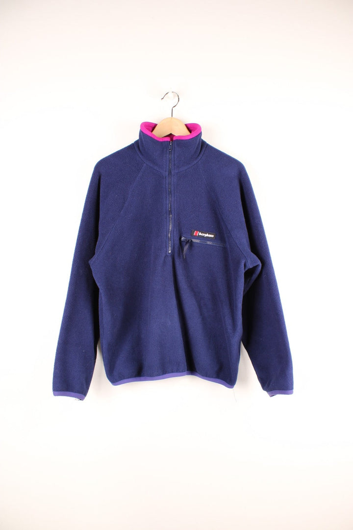 Dark blue Berghaus 1/2 zip fleece with pink around the collar, a zipped pocket, and an embroidered logo.  