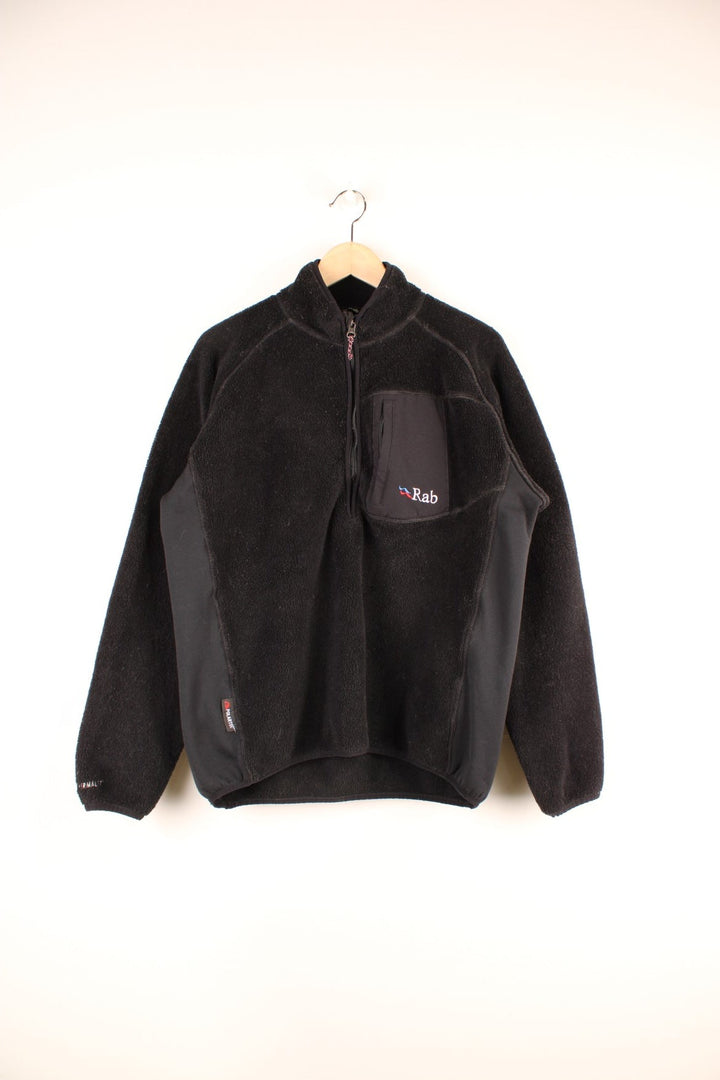 Black Rab Extreme 1/2 zip fleece with a zipped breast pocket and embroidered logos on the chest, hem and sleeve.  