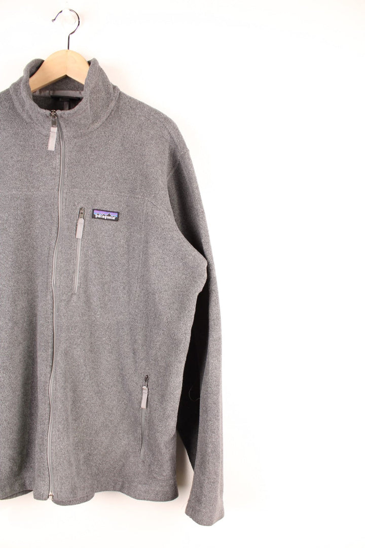 Grey Patagonia Synchilla zip-up fleece with three zipped pockets and an embroidered logo on the chest.