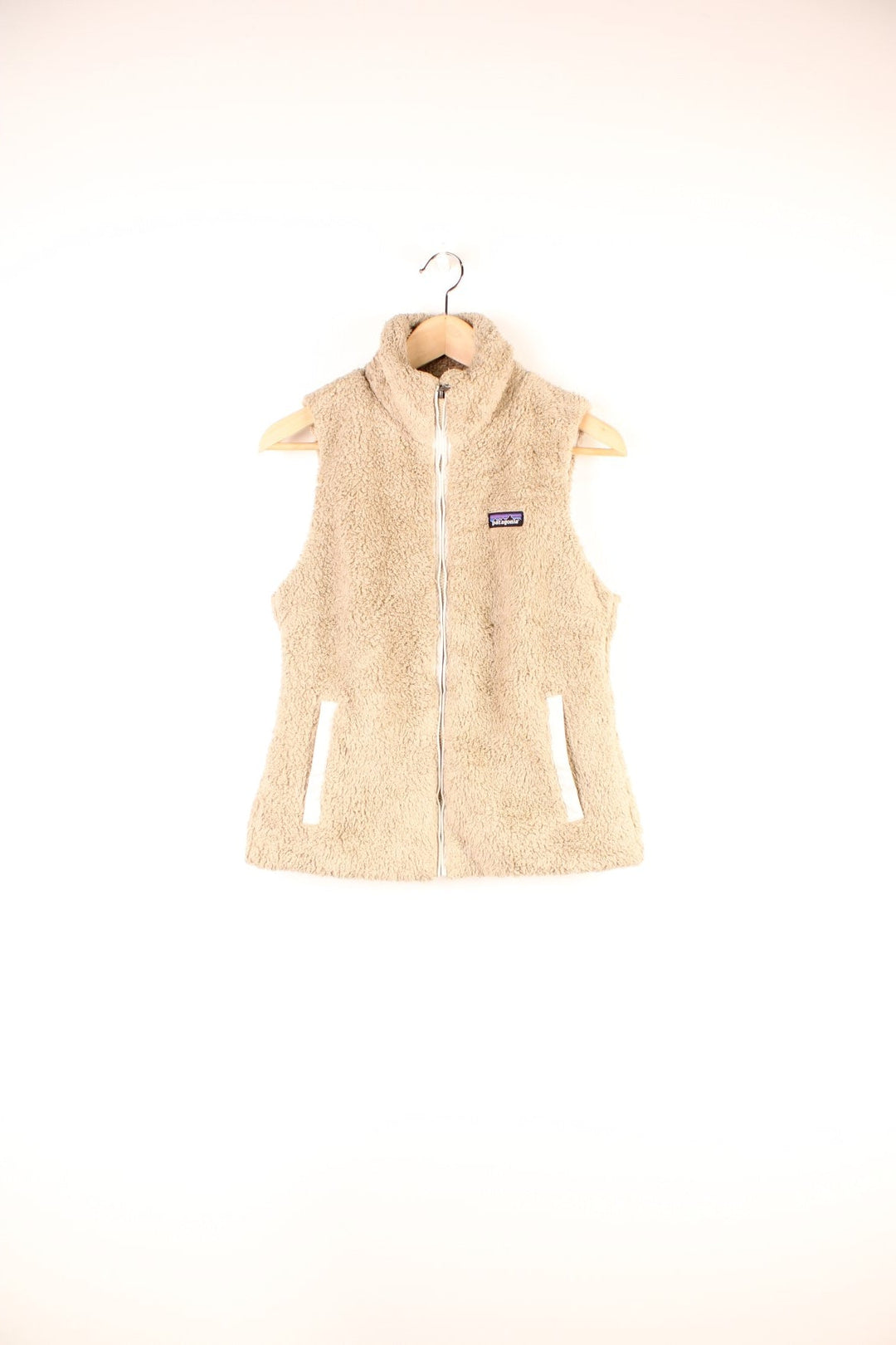 Tan Patagonia fluffy fleece gilet with zip closure, two zipped pockets and an embroidered logo on the chest. 